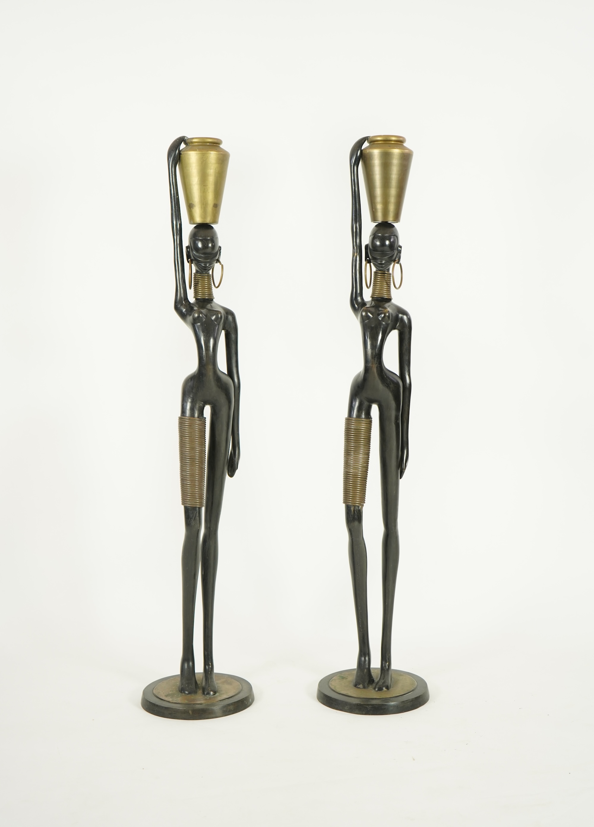 A large pair of Hagenauer style ebonised bronze 'Giraffe Woman' figures